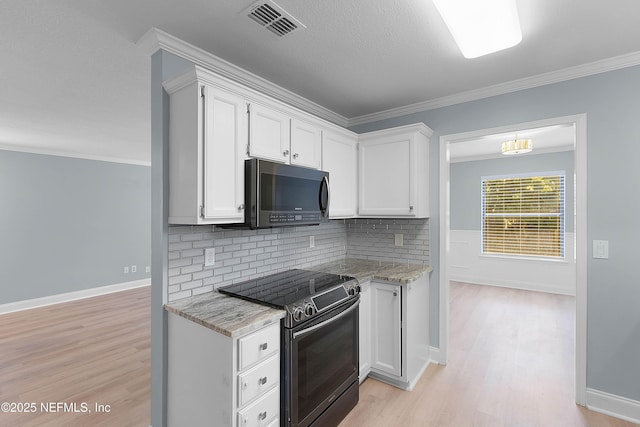 kitchen with electric range, ornamental molding, stainless steel microwave, white cabinetry, and light wood-style floors