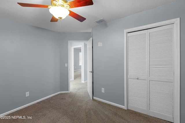 unfurnished bedroom featuring a closet, visible vents, carpet flooring, and baseboards