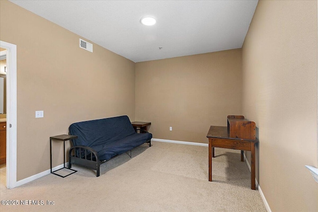 living area featuring light colored carpet