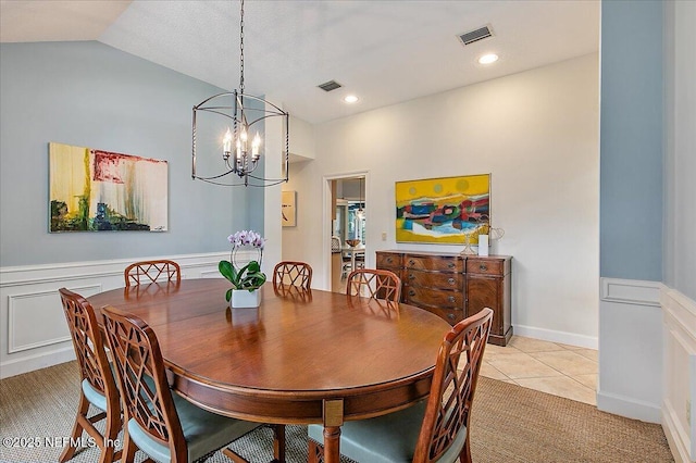dining room with a chandelier, light tile patterned flooring, vaulted ceiling, and recessed lighting
