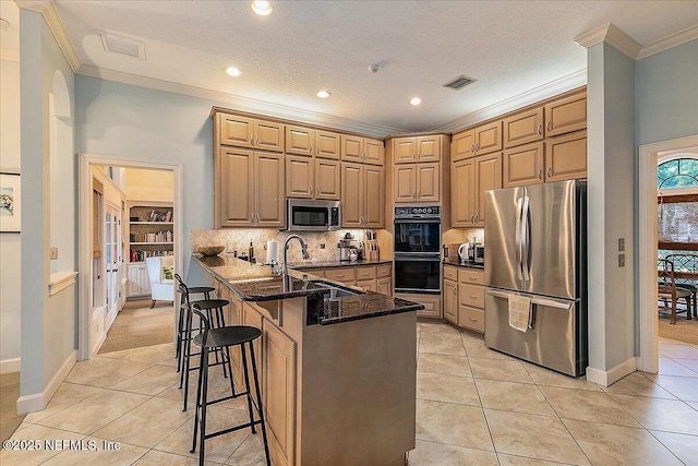kitchen featuring appliances with stainless steel finishes, ornamental molding, a sink, light tile patterned floors, and tasteful backsplash