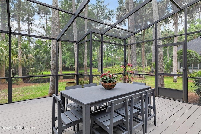 sunroom / solarium featuring outdoor dining area
