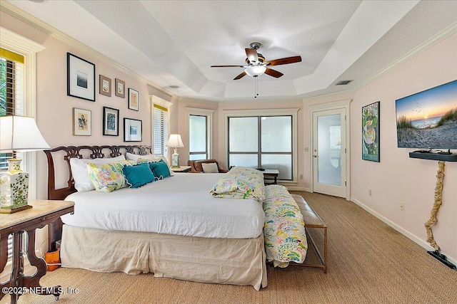 carpeted bedroom featuring a tray ceiling, access to exterior, baseboards, a ceiling fan, and crown molding