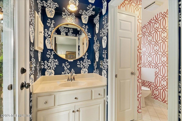 bathroom with wallpapered walls, tile patterned floors, toilet, and vanity