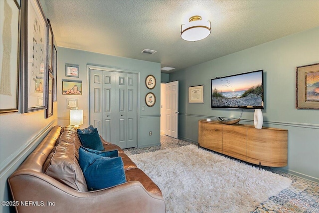 sitting room featuring baseboards and a textured ceiling
