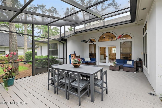 sunroom featuring an outdoor living space, french doors, and outdoor dining area