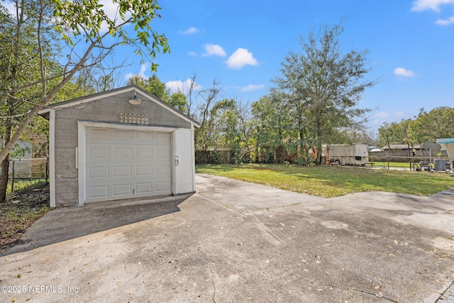 detached garage with driveway and fence