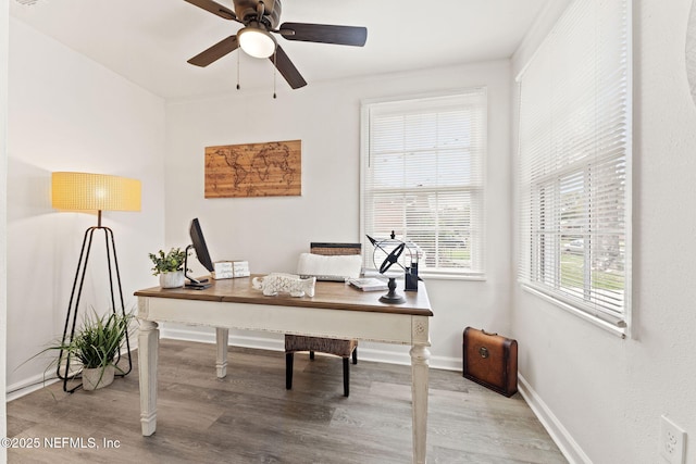 office area featuring wood finished floors, a ceiling fan, and baseboards