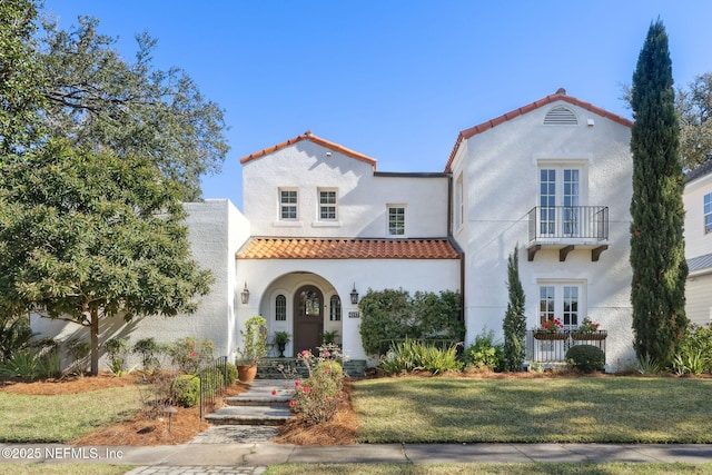 mediterranean / spanish-style home with french doors and a front yard