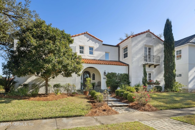 mediterranean / spanish-style home with a front yard