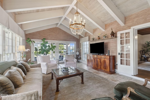 living room featuring french doors, a notable chandelier, beamed ceiling, wooden ceiling, and high vaulted ceiling