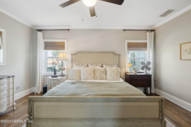 bedroom with multiple windows, dark wood-type flooring, and ornamental molding