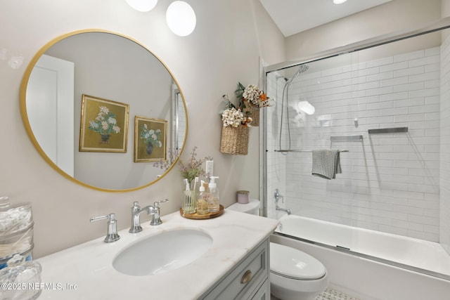 full bathroom featuring vanity, combined bath / shower with glass door, and toilet