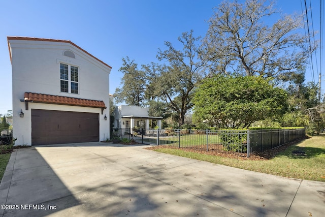 mediterranean / spanish home featuring a garage and a front yard