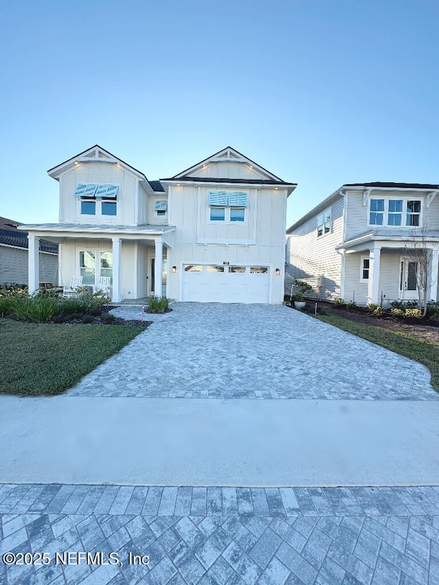 view of front of house featuring covered porch and a garage