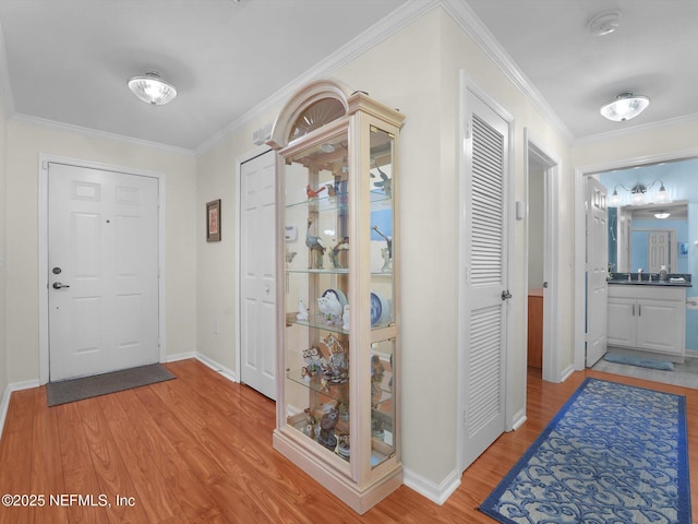 4306 Serena Cir, Saint Augustine, FL 32084 - entryway featuring light wood-type flooring, crown molding, and baseboards