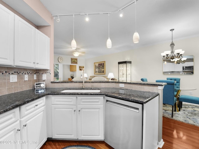 4306 Serena Cir, Saint Augustine, FL 32084 - kitchen with track lighting, white cabinetry, stainless steel appliances, a sink, and wood finished floors