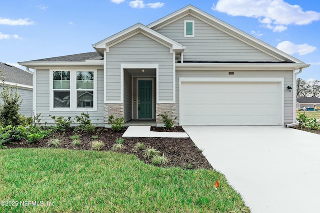 view of front of home with a garage, a front lawn, and concrete driveway