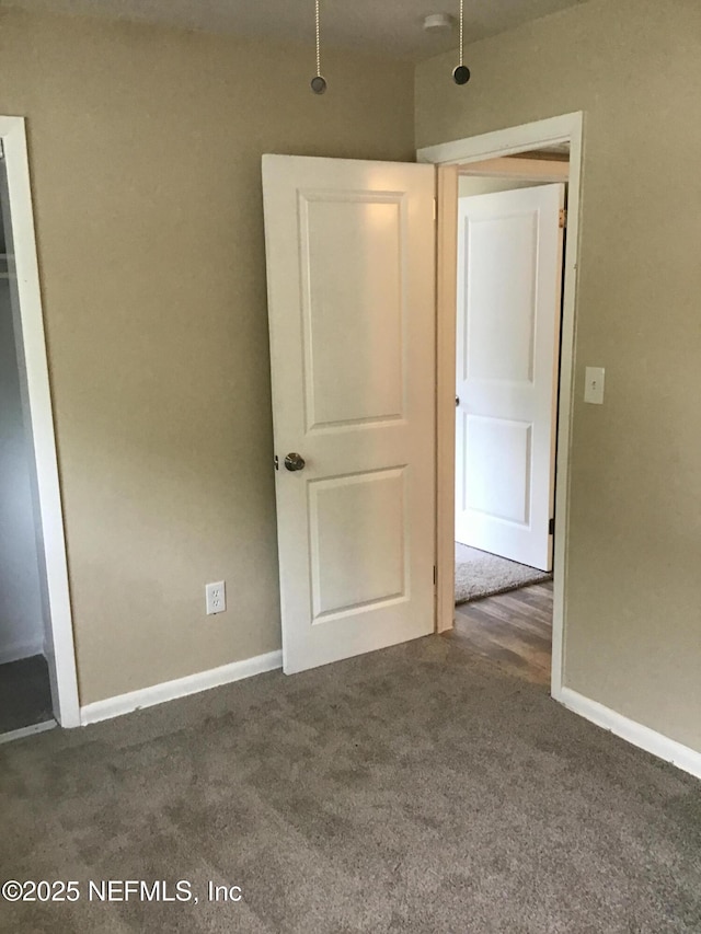 unfurnished bedroom with carpet and baseboards