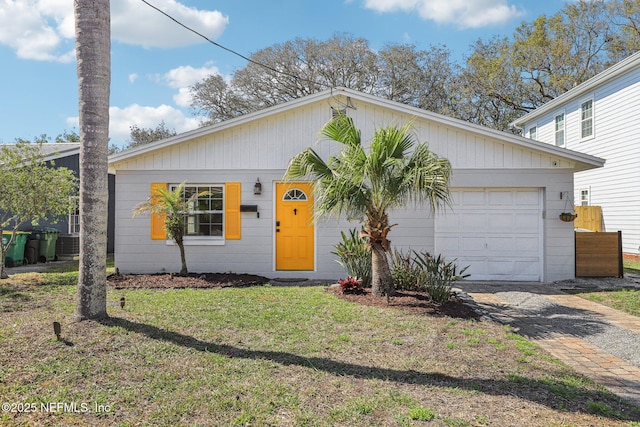 ranch-style home with a garage, a front lawn, and decorative driveway