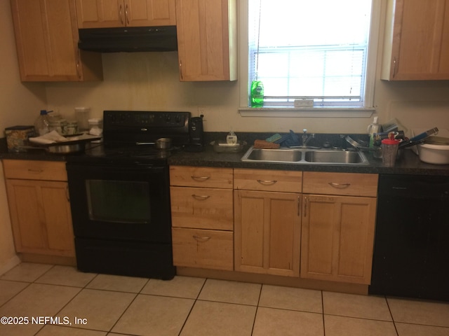 kitchen with dark countertops, under cabinet range hood, black appliances, a sink, and light tile patterned flooring