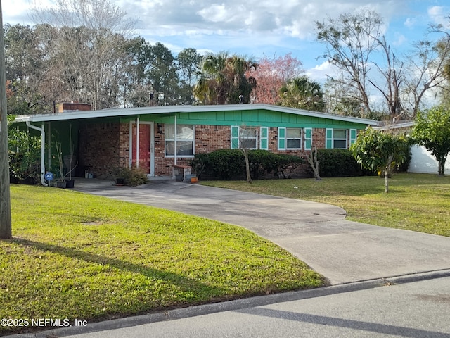 ranch-style house featuring a front lawn and a carport