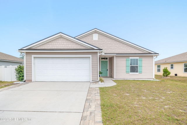 view of front of property featuring a front lawn and a garage