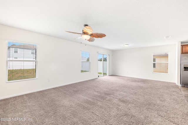 empty room with a textured ceiling, light carpet, and ceiling fan