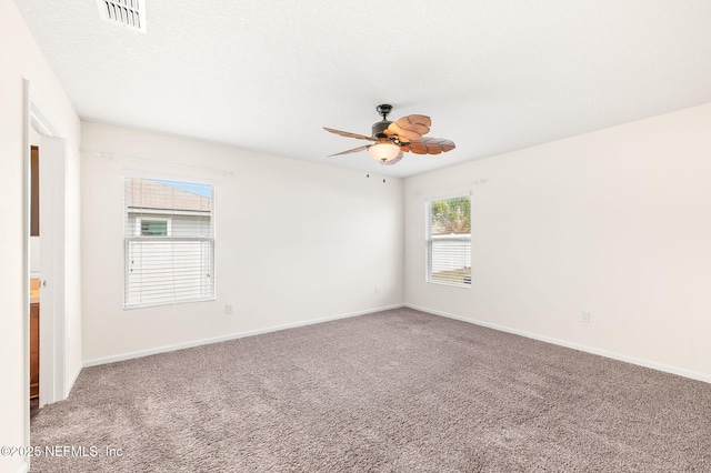 spare room with ceiling fan, carpet floors, and a textured ceiling