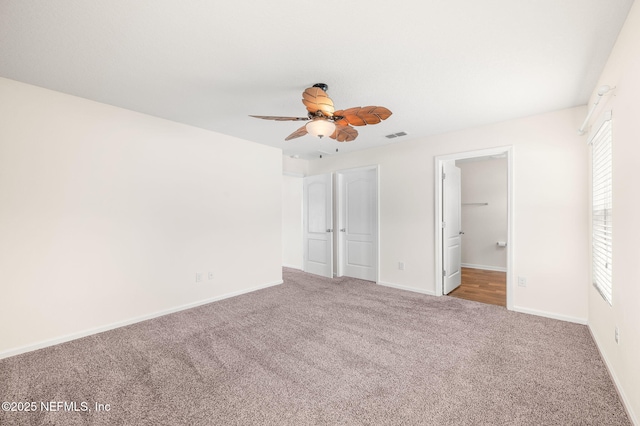 unfurnished bedroom featuring ceiling fan, carpet flooring, and connected bathroom