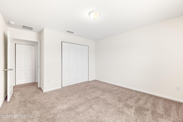 unfurnished bedroom featuring a closet and carpet floors