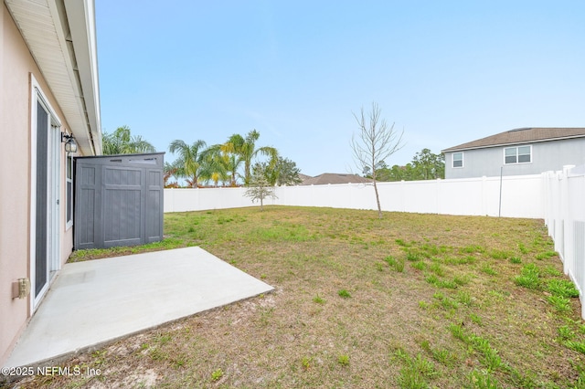 view of yard featuring a patio area and a storage shed