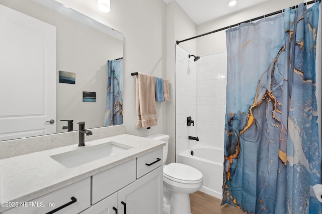 bathroom featuring shower / tub combo with curtain, vanity, toilet, and wood finished floors