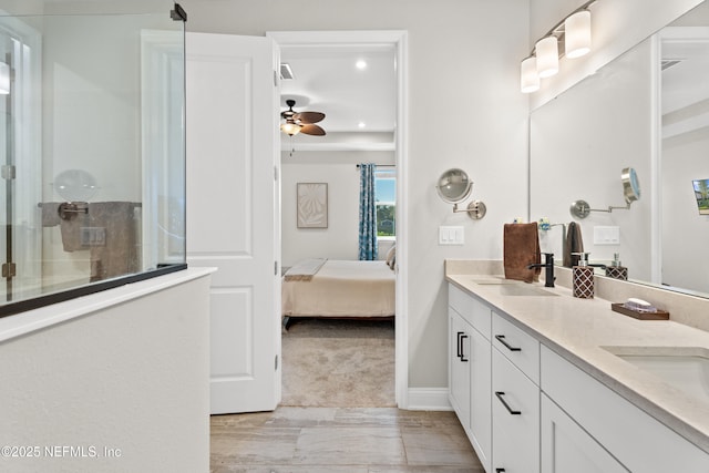 full bath featuring double vanity, ceiling fan, ensuite bathroom, walk in shower, and a sink