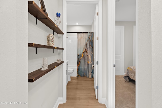 walk in closet featuring light wood finished floors