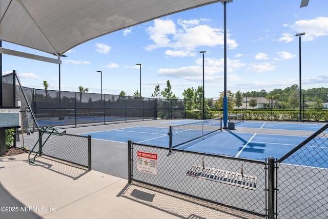 view of tennis court with fence