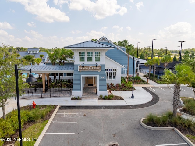 view of property featuring uncovered parking and fence