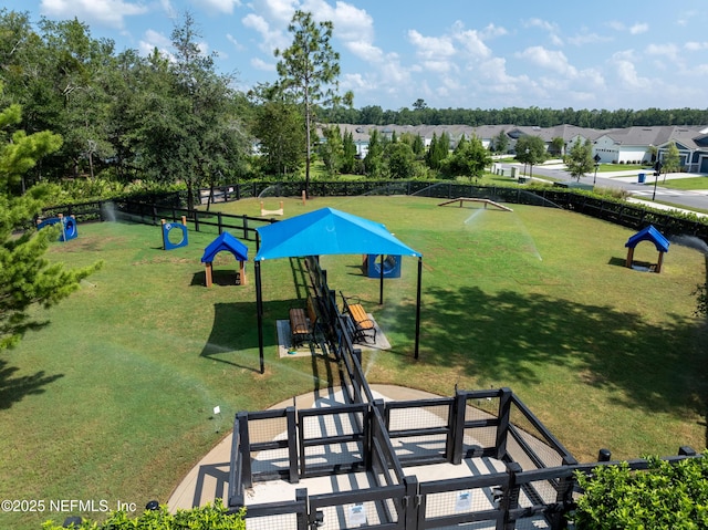 view of home's community with a yard, fence, and a residential view