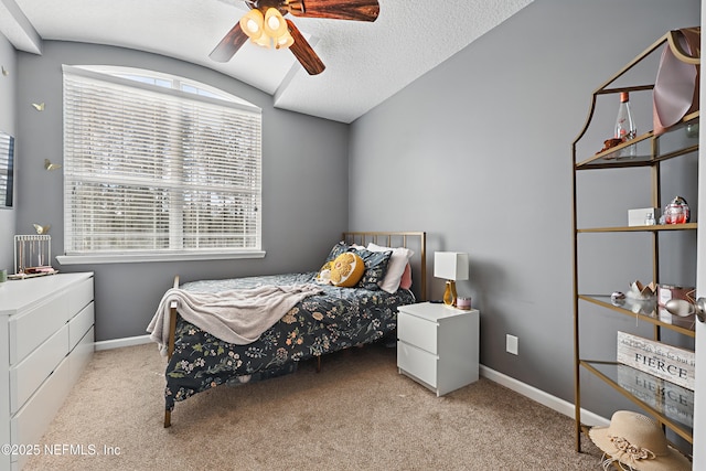 bedroom with lofted ceiling, baseboards, a textured ceiling, and light colored carpet