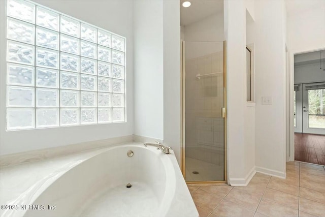 bathroom with separate shower and tub and tile patterned floors