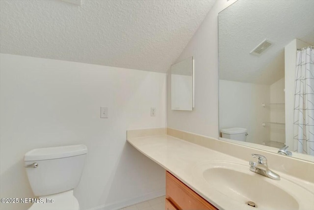 bathroom with toilet, a textured ceiling, vanity, and vaulted ceiling