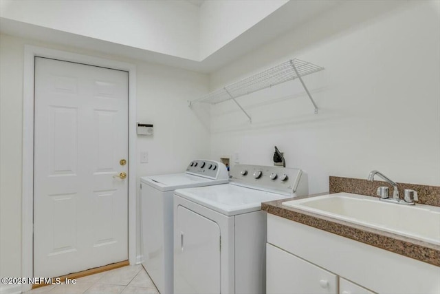 laundry area featuring sink, light tile patterned flooring, cabinets, and washer and dryer