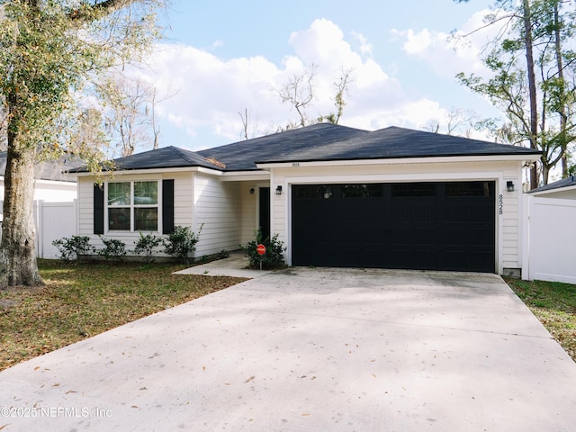 ranch-style house featuring a front lawn and a garage