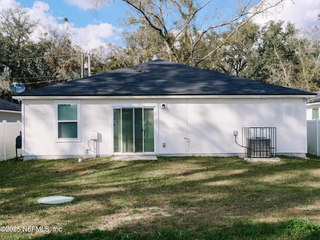 back of property featuring a lawn