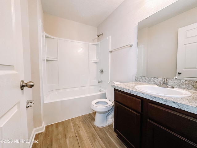 full bathroom with hardwood / wood-style flooring, vanity, toilet, and shower / tub combination