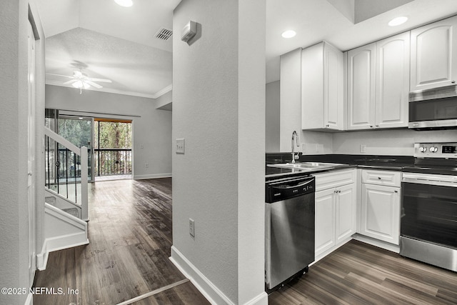 kitchen featuring sink, appliances with stainless steel finishes, white cabinets, and dark hardwood / wood-style flooring