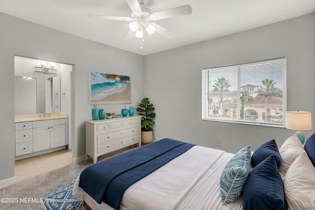 9745 Touchton Rd Unit 127, Jacksonville, FL 32246 - bedroom with a sink, ensuite bathroom, light tile patterned floors, a ceiling fan, and light colored carpet