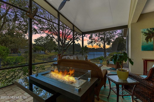 sunroom / solarium with a healthy amount of sunlight and lofted ceiling