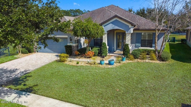 view of front of house featuring decorative driveway, a front lawn, and stucco siding