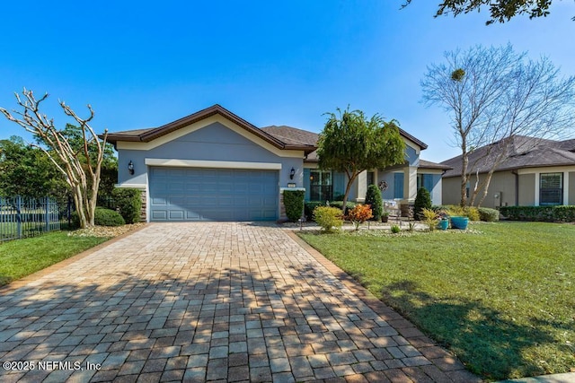 view of front of property with a garage, stucco siding, fence, decorative driveway, and a front yard